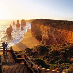 Scenic beach cliffs under golden sunset sky