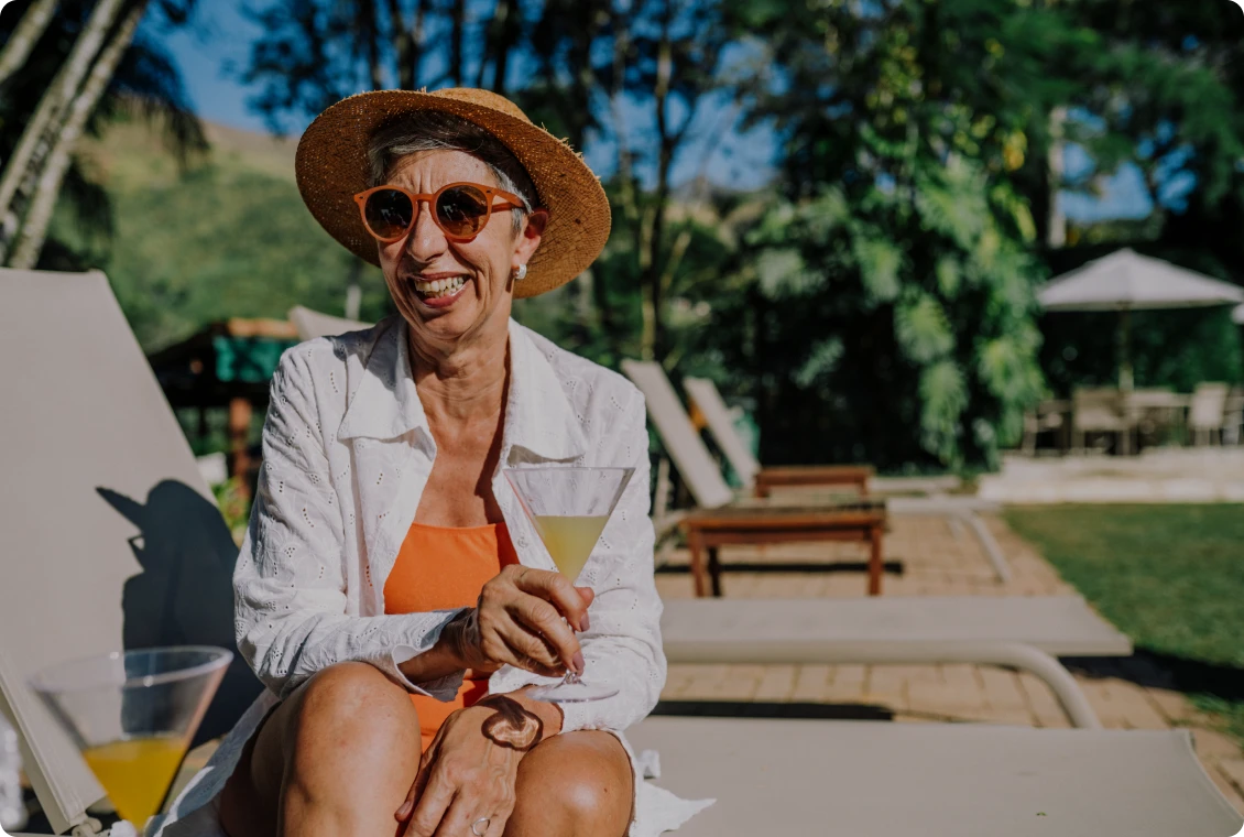 Happy woman with drink on sunny day