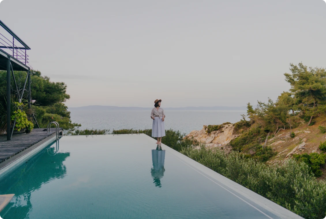 Woman overlooking ocean view from poolside