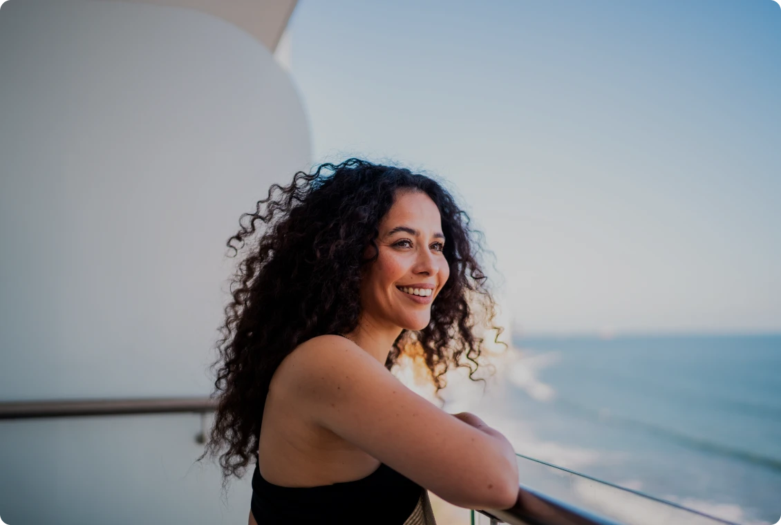 Relaxed woman gazing at the ocean